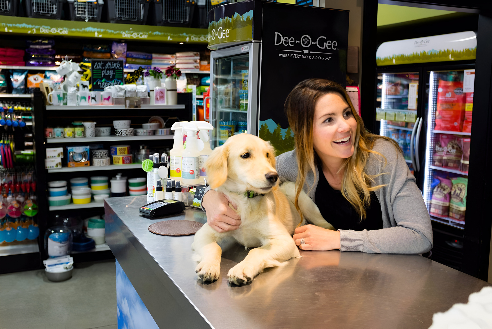 a woman sitting at a counter with a dog